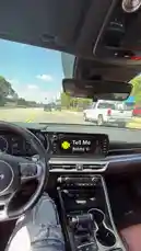 A first-person view from inside a car on a sunny day, driving down a road with other vehicles. The car's infotainment screen displays the song 'Tell Me' by Bobby V, which is playing from the audio. This creates a personal and immersive experience, capturing the feeling of listening to music while driving. by @quezz.706 with Tell Me by Bobby V.