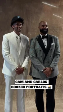 In a behind-the-scenes look at a professional photoshoot, an NBA player in a sharp white suit poses alongside a celebrity coach in a stylish plaid tuxedo. The pair share a moment of camaraderie, smiling and interacting warmly under studio lights before shaking hands. This candid moment captures the blend of athletic fame and polished style. by @nba with Original Sound by nba