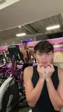 In this energetic clip, S E B A S 🧸 is seen having fun on an exercise bike inside a gym. He starts by playfully covering his mouth before launching into a series of animated dance moves and exaggerated actions, clearly enjoying himself. In the background, another man can be seen working out on a similar machine. by @twinksebass with Original Sound by twinksebass