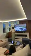 In a modern living room, fans of Jennifer Lopez erupt in cheers and excitement while watching a college basketball game on TV. The scene captures the intense energy and camaraderie of sports fans celebrating a thrilling moment together. by @jlobts with Original Sound by jlobts