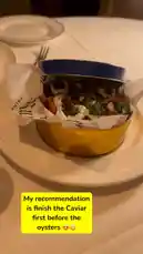This close-up video captures a beautifully presented meal at a fine dining restaurant, showcasing a vibrant dish served in a distinctive yellow tin. The camera pans across the table, revealing other gourmet courses and elegant tableware, creating an immersive experience of a high-end culinary event. by @delwinbazilme with want u by Noevdv