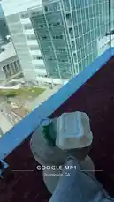오리지널 사운드 포함 @tufavlatiino 님이 만든 A person enjoys a drink on a high-rise balcony overlooking a sprawling office park and parking lot on a clear day.