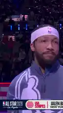 This video captures Boston Celtics star Jaylen Brown during the NBA All-Star 2026 event in Los Angeles. He is seen wearing the official USA team jacket, smiling and posing for the cameras in front of a massive arena crowd. The atmosphere is electric, with fans holding up lights and large screens displaying his image, highlighting his status as a top player. by @celtics with Original Sound by celtics