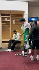A behind-the-scenes look inside the Boston Celtics locker room after a game. A player in a black tracksuit addresses his teammates, congratulating one of them on his first career start and praising the team's physical effort and unity. The atmosphere is celebratory and focused, capturing a moment of team bonding and post-game reflection. by @celtics with Original Sound by celtics