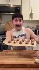 In a modern kitchen, Timur presents a collection of ingredients including Nutter Butter cookies, Snyder's Mini Pretzels, M&M's, and Hershey's chocolate bars. He then proceeds to prepare a treat using these items. by @onelimbtim with Original Sound by onelimbtim
