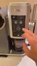 Watch this concise tutorial on using a Ninja coffee maker. A hand demonstrates selecting the 'Scoop' setting, adjusting the number of cups, and starting the brewing process. The machine begins to operate, showing the digital display counting down. This practical guide covers the basics of operating a modern coffee appliance. by @alysf90 with Original Sound by alysf90