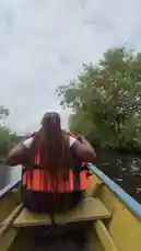 This scenic point-of-view video follows Efia Adanals as she rows a yellow canoe through a narrow river. Surrounded by dense green trees and vegetation under an overcast sky, she navigates the calm waters, creating a peaceful and immersive experience. by @naa.ayele911 with original sound