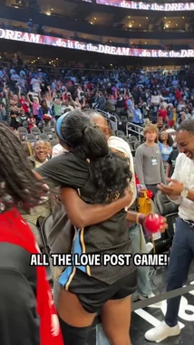A WNBA player celebrates her team's victory by sharing heartfelt hugs and high-fives with fans in the stands after the game. She interacts warmly with supporters of all ages, creating a joyful and connected atmosphere in the arena. by @wnba with Original Sound by wnba