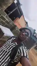 A stylish individual, identified as Ħølÿ MolŁY, captures a confident selfie in an urban setting. Dressed in a black-and-white striped shirt, a beanie, and sunglasses, they strike a pose against a weathered brick wall under natural light. The scene exudes a casual, streetwear vibe, showcasing personal style in a real-world environment. by @big20247443 with Eti romipin abi😂😂 by Chicken 😂