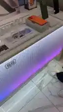A hand picks up and showcases the new Infinix Note 60 Pro smartphone. The phone is shown from multiple angles, highlighting its vibrant orange back panel with a distinctive camera module and its front display, which shows the 'Infinix NOTE60Pro' branding. by @point_tech1 with Original Sound by point_tech1