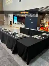 The video shows multiple chess sets arranged on black-draped tables inside a modern exhibition hall. In the background, a large sign reads 'ABSOLUTE ZERO' with '1920-1926 & BEYOND'. A partial view of a 'GALLERY OF SCIENCE' sign is visible on the wall. The setting suggests a science museum event or exhibit where chess is being showcased, possibly as part of a historical or educational display. by @chesscom with original sound