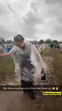 A woman in a clear poncho dances joyfully in a muddy field during a rainy festival. She smiles and moves her arms to the music, surrounded by other attendees enjoying the event despite the wet weather. by @snapcreators with Original Sound by snapcreators