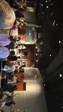 This vertical video offers a unique perspective from within a large church congregation during a lively worship service. The camera pans across rows of people actively participating, many with their hands raised in praise. On stage, a band performs under professional lighting rigs, with lyrics projected onto screens. The atmosphere is energetic and communal, showcasing a modern church service. by @kochkinmax with kochkinmax by Original Sound