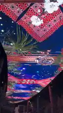 Experience a captivating digital art installation by Bader Alodah. This mesmerizing light show features intricate geometric patterns, vibrant reds and blues, and elegant lantern-like structures floating against a deep blue backdrop. The dynamic display, enhanced by reflections and the presence of palm fronds, creates a magical and immersive atmosphere. by @guruofmarketing with original sound