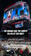 A packed State Farm Arena buzzes with energy as fans watch the WNBA game between the Atlanta Dream and the Las Vegas Aces. The jumbotron displays 'THE DREAM LEAD THE LIBERTY 56-54 AT THE HALF!' while the crowd celebrates under bright lights. This moment captures the excitement of a close WNBA matchup during halftime. by @wnba with original sound