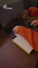 This video shows a person using a Qable power bank to charge a tablet and a smartphone. The phone screen displays 'Charging' and '41% Charged'. The video ends with a black screen showing the Qable logo, Arabic text translating to 'Download Qable', and contact information. by @qable_qa with Original Sound by qable_qa