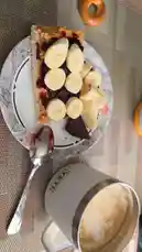 A close-up, appetizing look at a perfectly prepared breakfast toast topped with peanut butter, dark jam, and fresh banana slices. A hand points to the delicious layers, showcasing the textures and ingredients of this simple yet satisfying meal. by @kochkinmax with kochkinmax by Original Sound