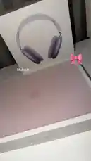 A close-up, unboxing-style video showcasing the new rose gold MacBook Neo laptop and its matching purple AirPods Max headphones. The Apple logo is clearly visible on the laptop's lid, and the packaging features a prominent image of the headphones. by @bx301a with Best part of my day by 🩷🎀🪄