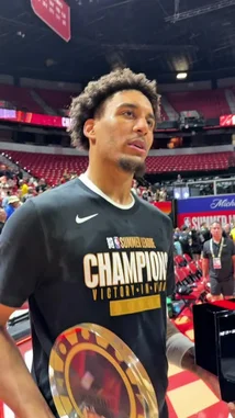 A young NBA player, wearing a 'Summer League Champions' shirt, speaks passionately to the camera after winning a championship. He holds a trophy and a ring box, expressing his gratitude to fans and reflecting on the experience and its significance for his future. by @nba with Original Sound by nba