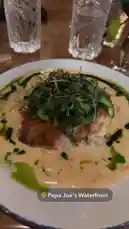 오리지널 사운드 포함 @itsma_bitchezz 님이 만든 A beautifully plated gourmet meal is presented, featuring a main course with a creamy sauce and fresh greens, accompanied by a side of rice in a cast-iron dish. The setting suggests a fine dining experience, capturing the essence of a sophisticated evening meal.