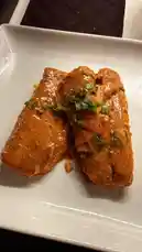 This close-up shot showcases a beautifully plated dish of chicken enchiladas smothered in a rich, creamy sauce and garnished with fresh green onions. The appetizing presentation highlights the texture and vibrant color of the meal, making it an ideal visual for anyone searching for delicious dinner ideas. by @riserachelruth with Original Sound by Contains: Homemade With Love - JongJunior