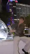 In this celebratory clip, S E B A S 🧸 marks their birthday with a stylish champagne pop in front of a glowing fountain at night. Dressed in a dark shirt and striped pants, they sit on the fountain's edge before joyfully opening the bottle, causing a festive spray. The urban skyline, including the Bank of America building, serves as a vibrant backdrop to the moment. by @twinksebass with Original Sound by Contains: It's Raining Men (Single Version) - The Weather Girls