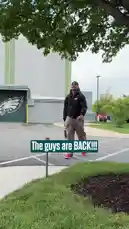 A montage of Philadelphia Eagles players arriving at their training facility for the start of the offseason program. The team members walk towards the building, greeted by on-screen text like 'The guys are BACK!!!' and 'Welcome back!'. The scenes capture the early morning atmosphere as the roster returns to prepare for the upcoming season. by @eagles with Original Sound by eagles
