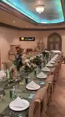 This video showcases a beautifully arranged long banquet table in an opulent dining hall, meticulously set for a formal event. White linens, crisp napkins, elegant glassware, and vibrant floral centerpieces adorn the table, ready for guests. In the background, a lavish buffet displays an array of desserts and hors d'oeuvres. The room features ornate ceiling details and ambient lighting, creating a sophisticated atmosphere perfect for weddings, galas, or high-end corporate dinners. by @levelstars7 with original sound