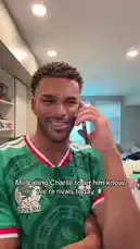 In this short clip, Jeremiah Brown, wearing a green Mexico national team jersey, makes a playful phone call to someone named Charlie. With a smile, he tells him they are rivals today, setting up a friendly competition. The scene captures a lighthearted moment of sportsmanship. by @findjeremiah with Original Sound by findjeremiah