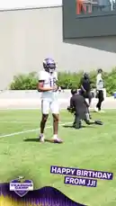 A Minnesota Vikings football player, wearing his team uniform, shares a special moment during training camp by greeting and interacting with young fans. The scene captures the player shaking hands with children, including one in a Vikings jersey, creating a heartwarming birthday celebration. The atmosphere is lively and positive, highlighting the connection between professional athletes and their community. by @vikings with original sound