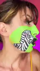 In this captivating face paint transformation, artist Martine Beerman brings a zebra and a lion to life on her cheek. The vibrant green base color serves as a canvas for the detailed animal portraits, which she animates with expressive mouth movements. This creative display of body art showcases her skill in transforming her appearance into a living work of art. by @martine with Original Sound by martine