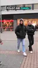 A young man approaches people on a city street asking if they follow 'Finnel'. When one woman confirms she does, he buys her a pair of Apple AirPods as a surprise gift. The video captures their conversation, his decision to buy the headphones inside a Saturn electronics store, and the joyful reaction of the recipient. by @finnel with Original Sound by finnel