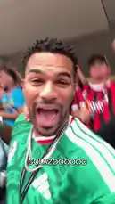 A fan, identified as Jeremiah Brown, passionately celebrates a goal during a soccer game. The scene captures his excitement up close before panning out to reveal a massive, packed stadium filled with cheering fans. A large overhead screen displays the word 'GOLAZOOOOO,' amplifying the celebratory atmosphere. by @findjeremiah with Original Sound by findjeremiah