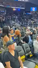 Witness a Golden State Warriors player share a special moment with a young fan in the stands after a game. The player retrieves a ball from the crowd, performs a celebratory dance on the court, and then returns to high-five the excited child. This authentic interaction captures the spirit of the Warriors' connection with their supporters. by @warriors with original sound