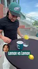Watch a Philadelphia Eagles player attempt a viral 'Lemon vs Lemon' balancing challenge. He tries to stack multiple lemons inside a glass of water, questioning if it's possible. This short-form content features a popular social media trend and a fan interaction moment. by @eagles with Original Sound by eagles