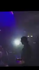 Witness a high-energy live performance by Wyatt Soderstrom in a packed nightclub. The atmosphere is electric with vibrant purple and blue stage lights, fog, and an enthusiastic crowd dancing and recording the show on their phones. Soderstrom, wearing sunglasses and a black shirt with 'STOLEN' on the back, commands the stage with a microphone, delivering a powerful set to the roaring audience. by @wyattsoderstrom with Original Sound by wyattsoderstrom