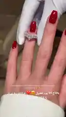 A close-up look at a stunning ruby and diamond ring being presented. The hand, adorned with red nail polish and white gloves, highlights the ring's intricate design and brilliance, perfect for holiday gifting. by @th4eb with Original Sound by th4eb