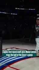 Eagles' first-round draft pick Makai Lemon rings the historic Liberty Bell during a special ceremony at a Philadelphia 76ers basketball game. Dressed in a 'Maxey 0' jersey and white pants, Lemon takes center stage on the court, swinging a mallet to ring the bell as fans and staff look on. This celebratory moment highlights his new chapter with the Eagles and his connection to Philadelphia sports culture. by @eagles with Original Sound by eagles