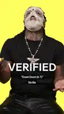 In a vibrant yellow-lit studio, rapper Skrrilla delivers a dynamic performance of his hit song 'Doot Doot (67)' for the music verification platform GENIUS. Wearing a distinctive white skull mask, black t-shirt, and prominent silver eagle pendant, he sings the lyrics while making expressive hand gestures. On-screen text displays the official lyrics in real-time, creating an immersive experience for fans. by @geniusverified with Original Sound by geniusverified