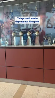 This short video chronicles the final days leading up to the New York Giants' first-round NFL draft pick. It begins with a display of Lombardi Trophies, transitions through practice fields and the team's training center, and concludes inside the locker room and a studio setting. The creator uses a countdown timer overlay to build anticipation for the draft event. by @newyorkgiants with newyorkgiants by Original Sound