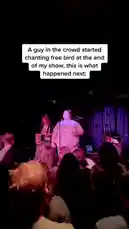 In a lively concert setting, a fan in the crowd begins chanting 'Free Bird' at the end of the performance. The band, including the lead singer and guitarist, reacts with surprise and amusement. The moment captures the spontaneous energy of live music and audience interaction. by @iamtalk with iamtalk by Original Sound