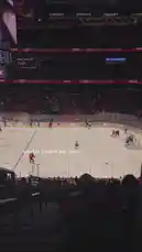 From the stands, witness the fast-paced action of a professional ice hockey game. Players in red and white jerseys battle for control near the goal, showcasing the skill and intensity of the sport. This authentic fan's-eye view highlights the excitement and energy of attending a live NHL event. by @squashha with squashha by Original Sound