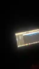 A close-up view of a computer screen displays a digital audio workstation (DAW) software interface, likely Logic Pro X, actively being used for music production. The timeline shows multiple blue audio tracks arranged in a sequence, with the playhead moving across them, indicating real-time editing or playback. This scene provides a behind-the-scenes look at the creative process of a music producer, showcasing the technical aspects of arranging and mixing audio tracks. by @nascarfeezy with Original Sound by nascarfeezy