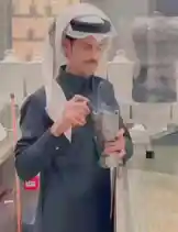 In this scene-by-scene walkthrough, we see Hussein Al Manhali demonstrating the proper use of a traditional incense burner. He carefully adds small pieces of aromatic wood into the intricately designed metal container, which begins to release fragrant smoke. Dressed in authentic attire including a white ghutra and black thobe, he performs the ritual with precision and focus, showcasing cultural customs related to fragrance and hospitality. by @hussain.2022a with hussain.2022a by Original Sound