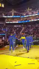 Witness the electrifying pre-game atmosphere as the Golden State Warriors take the floor at Chase Center. Players in their signature blue and yellow warm-up gear perform a dynamic team huddle and choreographed routine under the bright arena lights, captivating the roaring crowd before the game begins. by @warriors with original sound