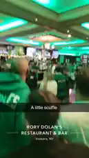 dassweenbean 님이 만든 Original Sound 포함 @dassweenbean 님이 만든 Experience the vibrant atmosphere of Rory Dolan's Restaurant & Bar in Yonkers, NY, during a bustling event. The venue is packed with guests, many dressed in green, under festive green lighting. Patrons are socializing, watching screens, and capturing the moment on their phones, creating a dynamic and energetic scene.