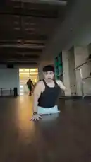 In a spacious dance studio, dancer Timur performs a captivating floor routine. He begins seated, then executes a fluid headstand before smoothly transitioning back into a seated position. With expressive arm movements and dynamic poses, he demonstrates impressive core strength and flexibility, all while wearing a black tank top and light-colored pants. by @onelimbtim with Original Sound by Contains: CHANEL - Tyla