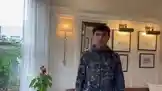 In a well-lit room with elegant decor, including framed art and a large mirror, K-DEV stands wearing a dark patterned jacket and purple pants. He speaks directly to the camera, using expressive hand gestures to emphasize his points. His demeanor suggests he is sharing a personal anecdote or explaining something important. by @k_dev170 with Original Sound by k_dev170