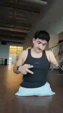Watch dancer Timur deliver an energetic floor routine in a dance studio setting. He performs fluid arm movements, spins, and expressive gestures while seated on a white cushion, showcasing his dynamic style. by @onelimbtim with Original Sound by onelimbtim