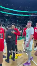 A post-game moment at TD Garden captures Anfernee Simons, now with the Chicago Bulls, reconnecting with his former Boston Celtics teammates. Players like Jayson Tatum and Jaylen Brown share smiles and embraces with Simons, highlighting the camaraderie in professional sports. The atmosphere is celebratory, with 'CELTICS WIN' displayed on the arena's jumbotron, marking a victory for the home team. by @celtics with Original Sound by celtics